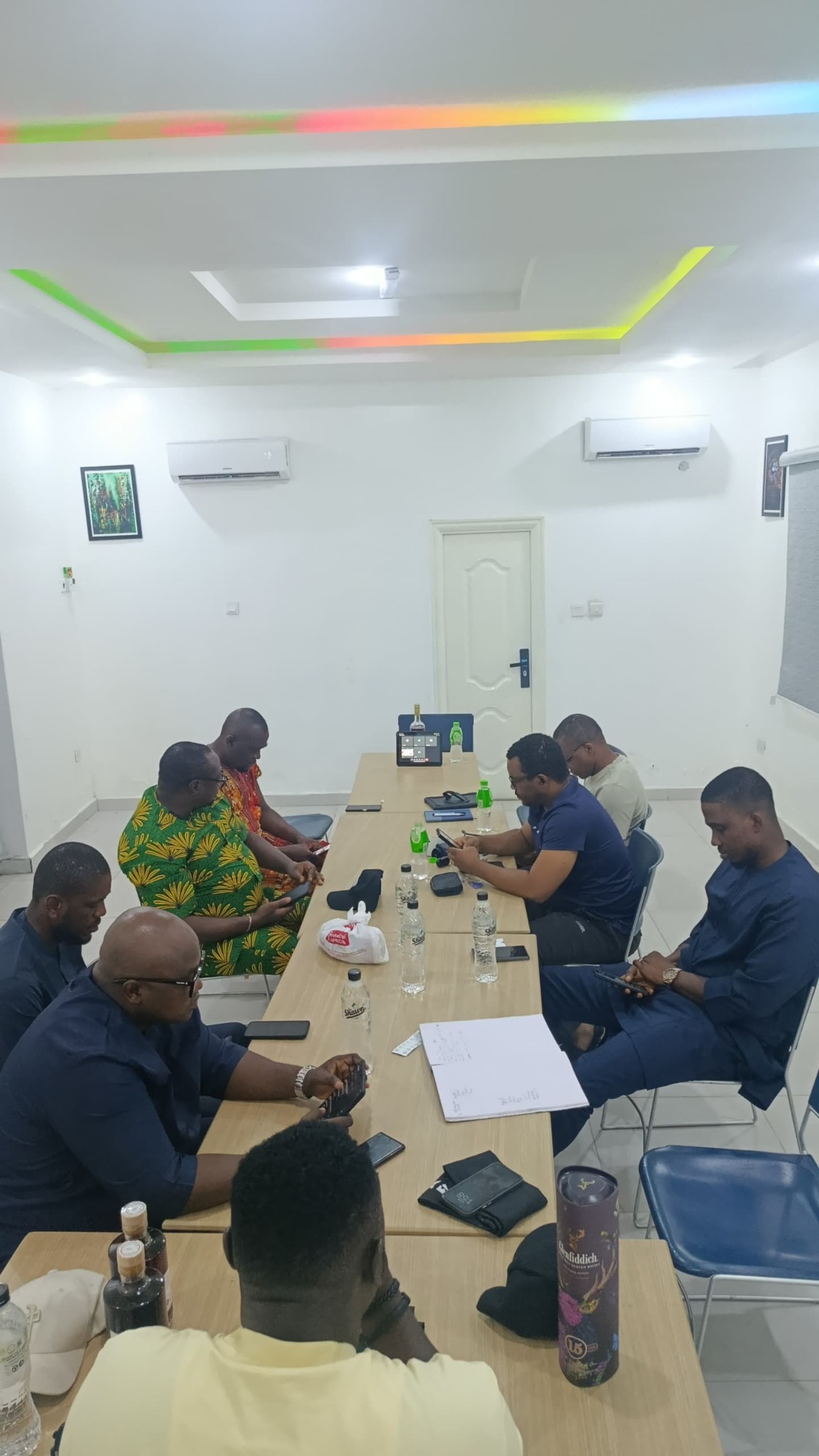PHF members seated around a meeting table during an in-person meeting